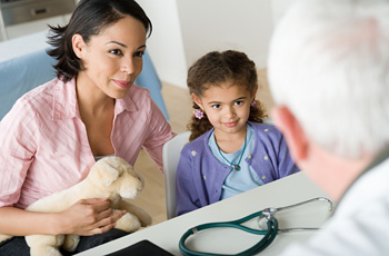 doctor talking to mother and child about child surgery